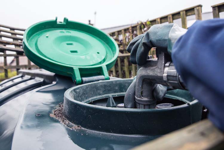 Heating oil delivery, nozzle placed into oil tank to refill